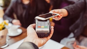 A customer uses their phone to make a mobile payment.