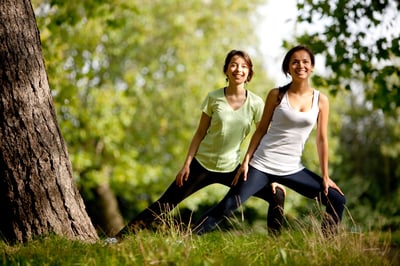 Beautiful women stretching at the park - fitness concepts