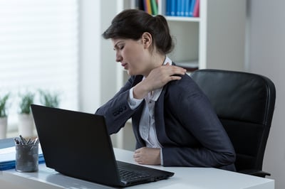 Businesswoman leading sedentary lifestyle causing back pain