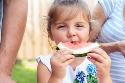 Candid portrait of a girl eating watermelon