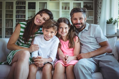 Happy family sitting on sofa at home