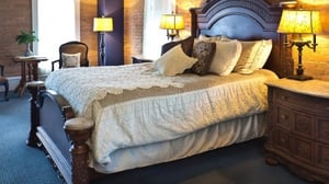 A hotel room with an ornate bed