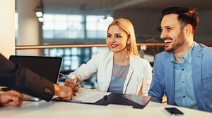 A young couple meets with an investment advisor