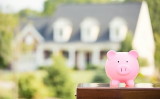 Real estate sale, home savings, loans market concept. Housing industry mortgage plan and residential tax saving strategy. Piggy bank isolated outside home on background. Focus on piggybank. Homeowner-2