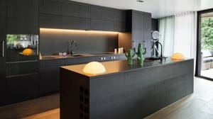 A modern kitchen with dark cabinets