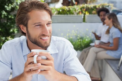 Thoughtful man having a coffee outside at the coffee shop